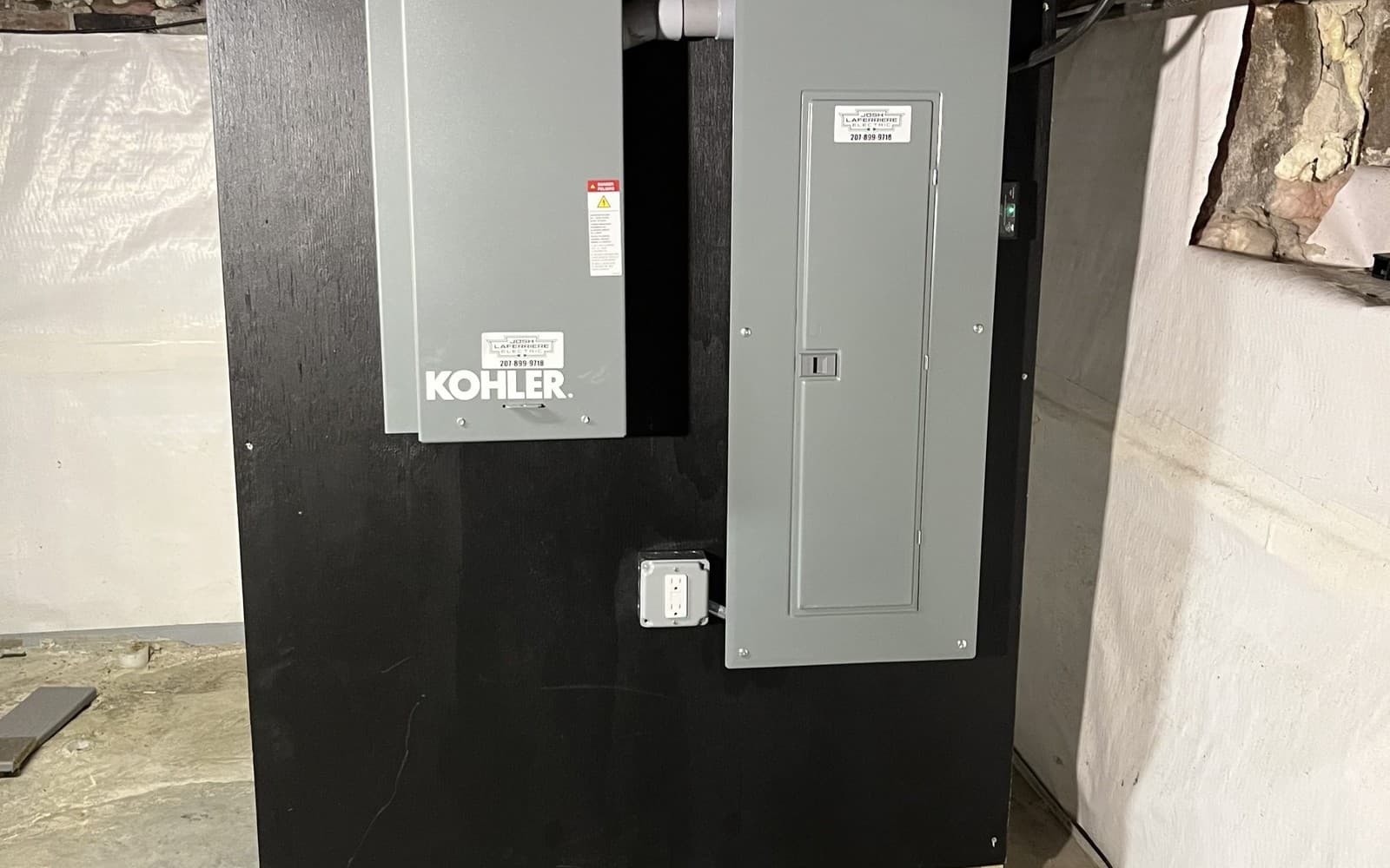 Electrical panel and generator transfer switch installation labeled Josh Laferriere Electric
